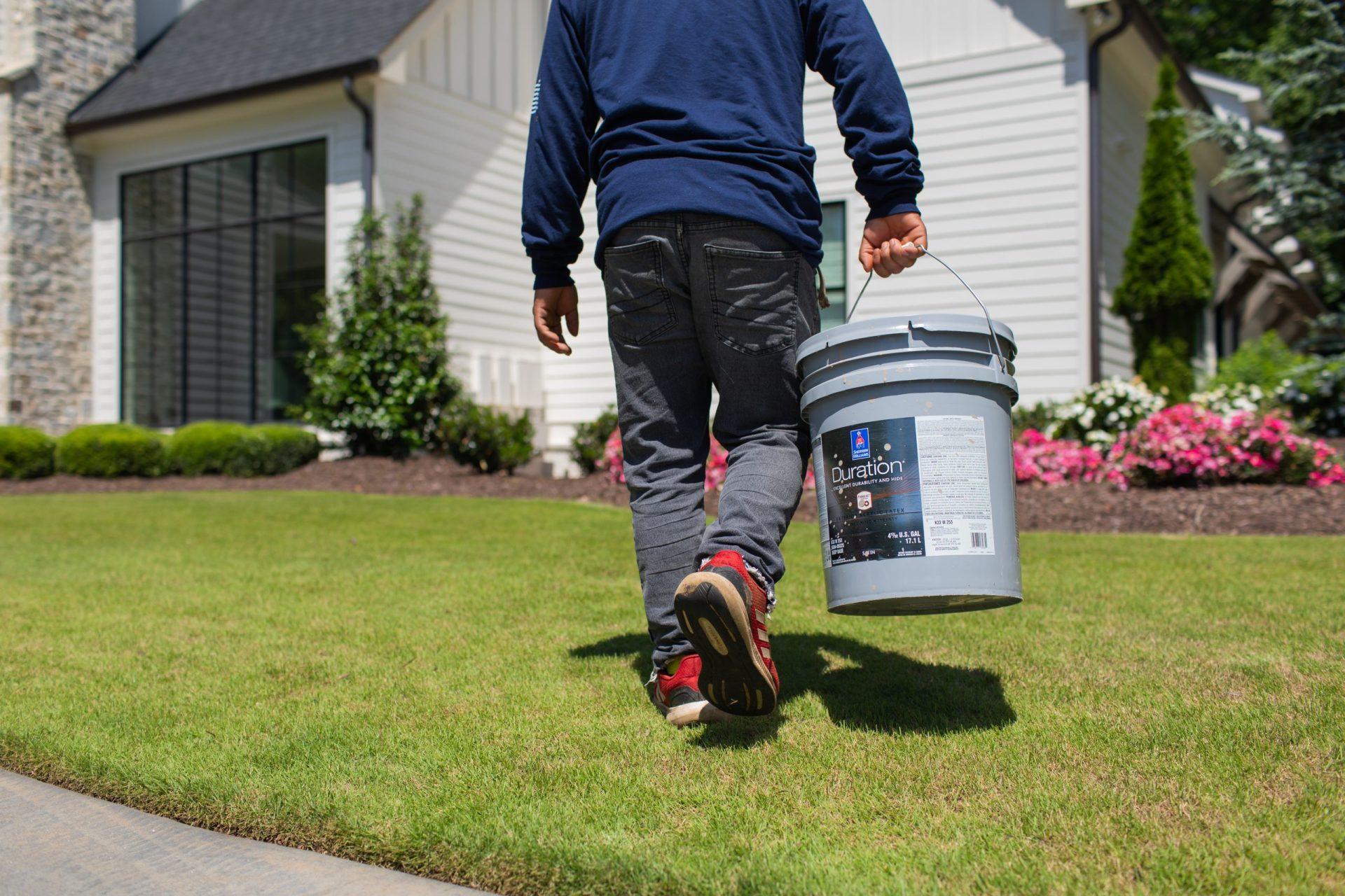 Clark Brothers team member applying Sherwin-Williams Exterior Paint Colors for 2026 to a Milton GA home