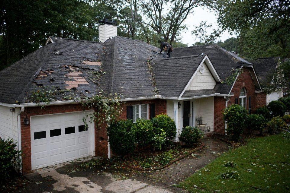 storm-damaged roof with missing shingles and visible wind damage in Atlanta