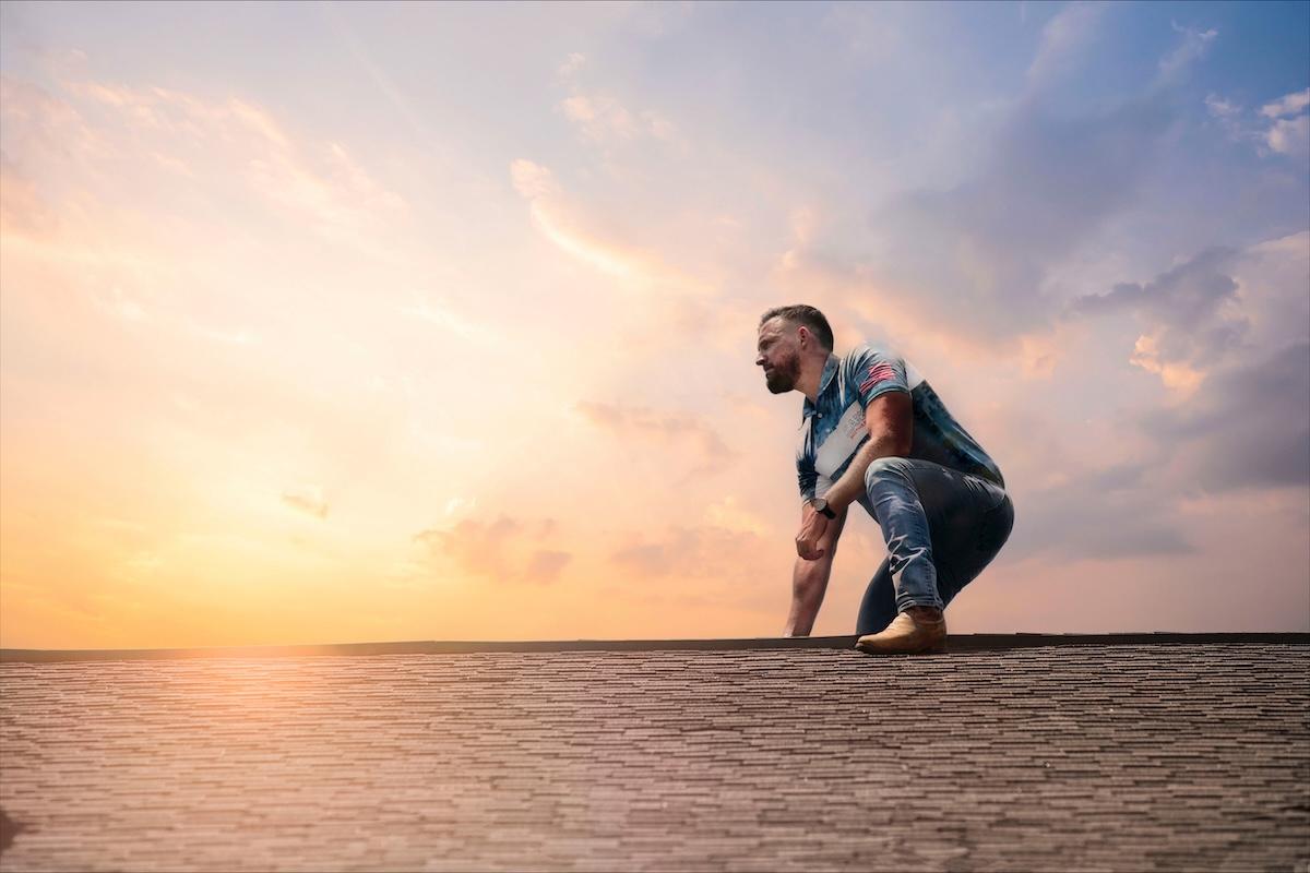 Clark Brothers roofing professional inspecting shingles before storm season in Georgia